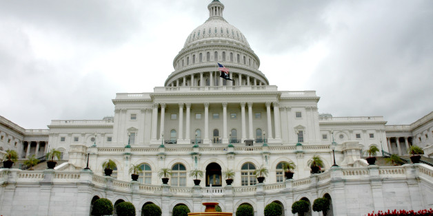United States Capitol with fountain on a cloudy day.