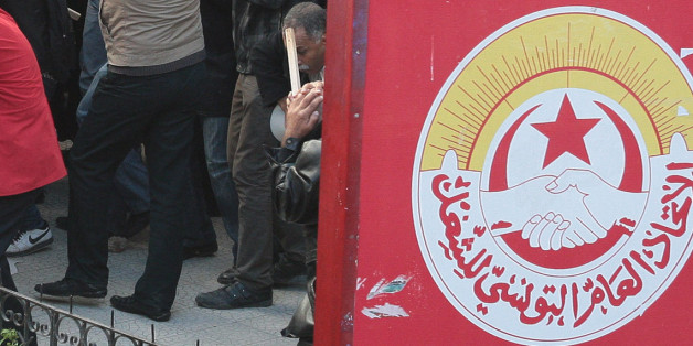 Members of the leftist UGTT union walk back during clashes with League members during a rally to commemorate the 1955 assassination of a historic member when they were attacked by the League for Protection of the Revolution, Tuesday, Dec.4, 2012 in Tunis. League members are considered to be close to the Ennahda Party, which dominates Tunisiaâs post-revolution coalition government (AP Photo/Amine Landoulsi)