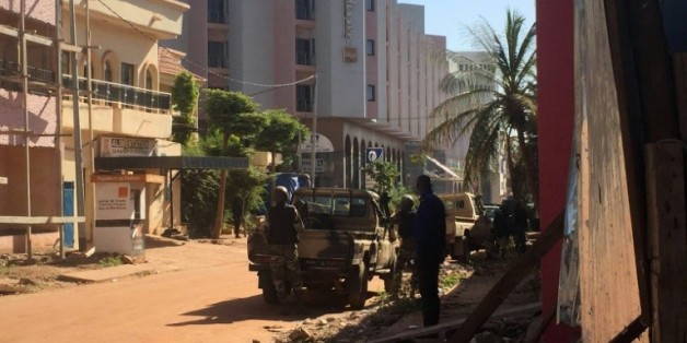 Des soldats maliens en position devant l'hôtel Radisson Blu où 170 personnes sont prises en otages par deux assaillants, le 20 novembre 2015 à Bamako, au Mali