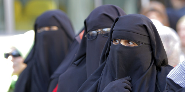 Egyptian women wearing "Niqab" line up outside a polling station to vote in the second round of a referendum on a disputed constitution drafted by Islamist supporters of President Mohammed Morsi in Giza, Egypt, Saturday, Dec. 22, 2012. (AP Photo/Amr Nabil)