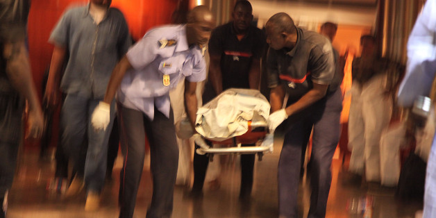 Mali security personal carry the body of a victim inside the Radisson Blu hotel after an attack by gunmen on the hotel in Bamako, Mali, Friday, Nov. 20, 2015. Islamic extremists armed with guns and grenades stormed the luxury Radisson Blu hotel in Mali's capital Friday morning, and security forces worked to free guests floor by floor. (AP Photo/Baba Ahmed)