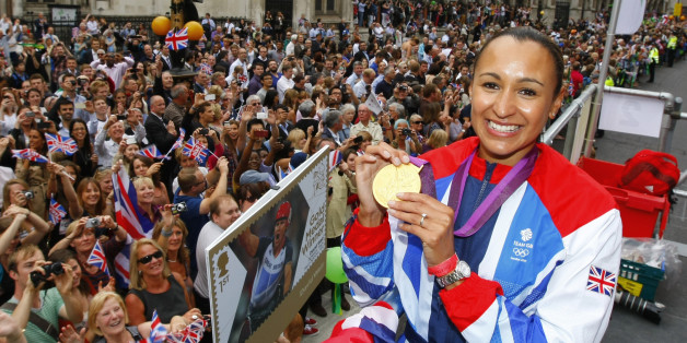 Britain's heptathlon Olympic gold medallist Jessica Ennis poses for a picture as her float passes the Royal Courts of Justice during a parade celebrating Britain's athletes who competed in the London 2012 Olympic and Paralympic Games in central London on September 10, 2012. Britain was bidding a fond farewell om September 10 to a golden summer of Olympic and Paralympic sport with a victory parade by athletes through London ending up at Buckingham Palace.