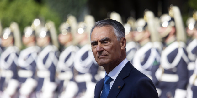 Portuguese President Anibal Cavaco Silva stands in front of a honor guard while waiting for the arrival of Senegal's President Macky Sall at the Belem presidential palace in Lisbon Tuesday, Sept. 8 2015. (AP Photo/Armando Franca)