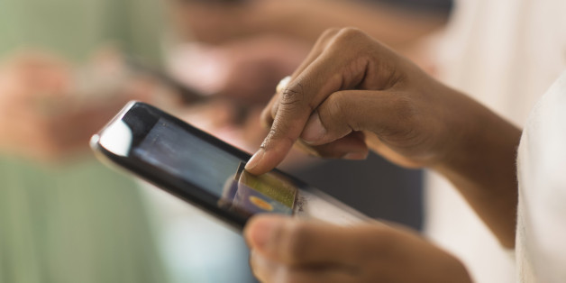 Close up of woman using cell phone touch screen