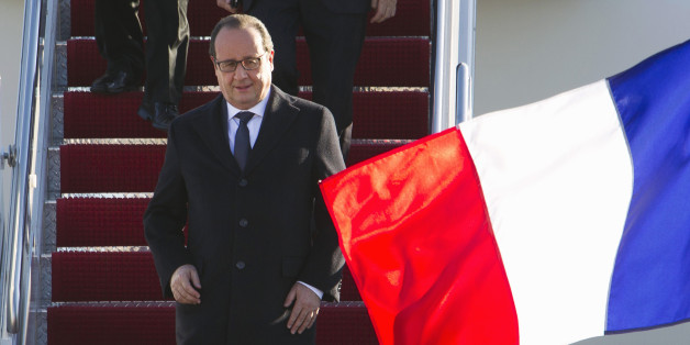 French President Francois Hollande walk down the stairs from his plane upon his arrival at Andrews Air Force Base, Md., Tuesday Nov. 24, 2015. Hollande will meet with President Obama at the White House. ( AP Photo/Jose Luis Magana)
