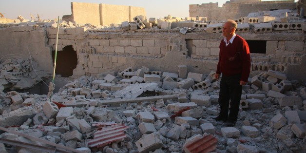 ALEPPO, SYRIA - NOVEMBER 20: A man stands on the debris of a building after the war crafts belonging to the Russian army bombed opposition controlled Ancient City of Aleppo in Syria on November 20, 2015. (Photo by Beha El-Halebi/Anadolu Agency/Getty Images)