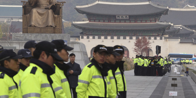 South Korean police officers stand guard near the Japanese Embassy for possible illegal protests against Japanese Prime Minister Shinzo Abe's visit in Seoul, South Korea, Monday, Nov. 2, 2015. After a three and a half year freeze, the leaders of South Korea and Japan resumed formal talks Monday that were expected to focus on North Korea's pursuit of nuclear bombs, trade ties and a long-running dispute over Japan's wartime atrocities. Seen in the background are the statue of King Sejong, the four