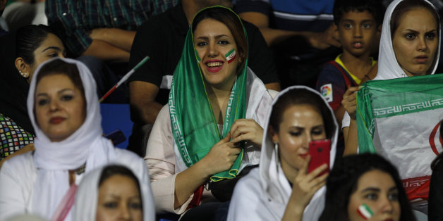 Iranian women watch the 2018 FIFA World Cup qualifying soccer match between Iran and India in Bangalore, India, Tuesday, Sept. 8, 2015. (AP Photo/Aijaz Rahi)