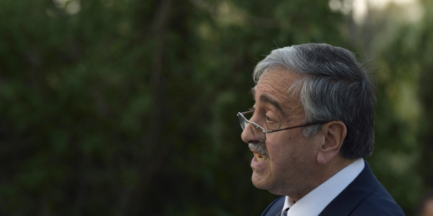 Turkish Cypriot leader Mustafa Akinci speaks during an event where he and Cyprus' president Nicos Anastasiades shared their respective visions for a Cyprus after a settlement inside the UN controlled buffer zone that divides the Cypriot capital, in Nicosia, Wednesday, July 8, 2015. Cyprus President Nicos Anastasiades and Turkish Cypriot leader Mustafa Akinci met during a special bi-communal event in the capital Nicosia organised by the respective Chambers of Commerce and Industry of both communities.(AP Photo/Pavlos Vrionides)