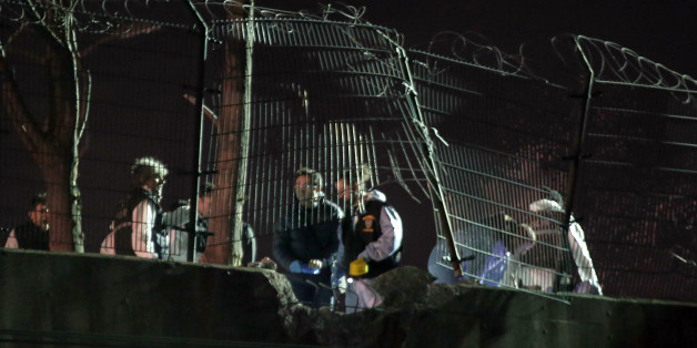 Police forensic officers investigate after an explosion on a highway overpass near a subway station wounded five people and was caused by a bomb, in Istanbul, Turkey, Tuesday, Dec. 1, 2015. The bomb was left on barriers on the overpass, said Atilla Aydiner, the mayor for Istanbul's Bayrampasa district.(AP Photo/Can Erok)