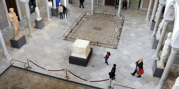 Tunisians stroll in Tunisia's National Bardo Museum Monday, March 30, 2015. The Bardo Museum is open to the public again for the first time since extremist gunmen opened fire on foreign tourists earlier this month, killing 22 people in the country's worst attack on civilians in 13 years. (AP Photo/Hassene Dridi)