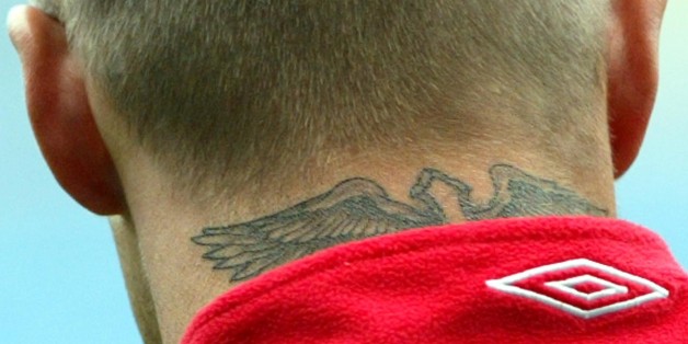 England captain David Beckham sports a new tattoo on the back of his neck, during a training session at the City of Manchester Stadium in Manchester, England, Monday May 31 2004. England play Japan in an international friendly on Tuesday, as part of their preparations for the Euro 2004 championships. (AP Photo/Paul Ellis)