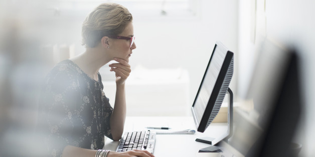 USA, New Jersey, Side view of business woman working on desktop pc in office