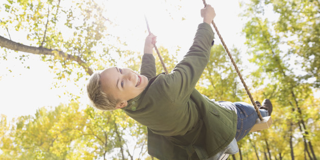 Portrait of cheerful woman swinging