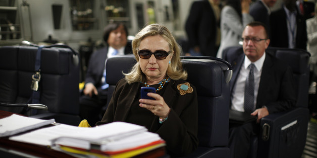 U.S. Secretary of State Hillary Clinton checks her PDA upon departure in a military C-17 plane from Malta bound for Tripoli, on October 18, 2011. AFP PHOTO/KEVIN LAMARQUE/POOL (Photo credit should read KEVIN LAMARQUE/AFP/Getty Images)