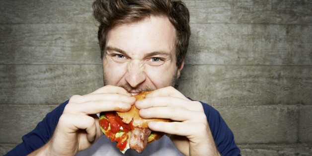 man eating hamburger