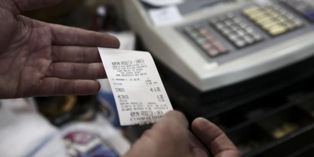 In this photo taken Sept. 30, 2015, Yiannis Fragiskos, owner of a souvenir shop, displays a receipt inside his shop at the port of the Greek Aegean island of Naxos. For decades, Greeceâs Aegean islands enjoyed a value added tax rate 30 percent lower than the rest of the country, to offset increased transportation costs and prevent their dwindling permanent populations from deserting them altogether, but now the islands are losing that benefit as part of creditor-demanded reforms for Greece'