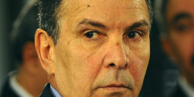 New Tunisian Defense Minister Farhat Horchani looks on during a taking oath ceremony in Tunis, Friday, Feb. 6, 2015. Prime Minister Habib Essid, whose cabinet has ministers from four parties including the powerful Islamists, promised "work and nothing but work" on the country's economic and security problems. (AP Photo/Hassene Dridi)