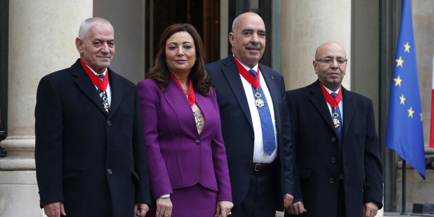 The four Nobel Peace Prize winners Houcine Abassi secretary general of the Tunisian General Labour Union, left, Wided Bouchamaoui president of the Tunisian employers, second from left, Abdessattar Ben Moussa president of the Tunisian Human Rights League, 2nd right, and Mohamed Fadhel Mafoudh head of the Tunisian Bar Association, right, pose for photographers after they receive Legion d'Honneur award, at the Elysee Palace, in Paris, Tuesday, Dec. 8, 2015. (AP Photo/Thibault Camus)