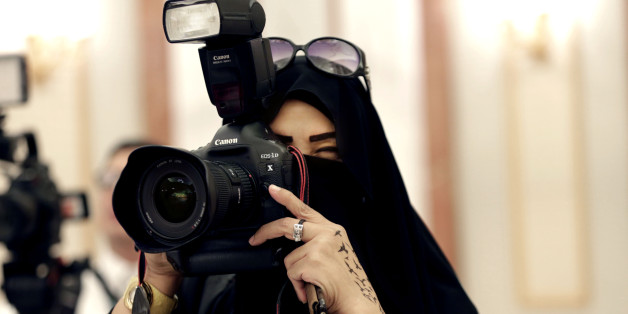 In this Tuesday, Nov. 10, 2015 photo, a journalist takes photos at a palace in Riyadh, Saudi Arabia. Outside the Saudi capital of Riyadh, in one of the country's most conservative provinces, Jowhara al-Wably is making history by running as a female candidate in upcoming elections. Saturday's vote for municipal council seats marks two milestones for Saudi women: It is the first time women are allowed to vote in a government election and the first time women can run as candidates. (AP Photo/Hasan