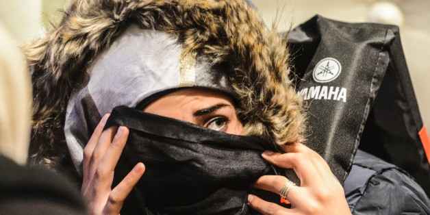 A Syrian migrant woman waits aboard the Turkish Coast Guard ship Umut after being rescued while attempting to reach the Greek Island Chios on the Agean Sea near Izmir in the night of December 9 to December 10, 2015.
More than 886,000 migrants have arrived in Europe by sea so far this year, according to the latest UN figures. / AFP / BULENT KILIC (Photo credit should read BULENT KILIC/AFP/Getty Images)