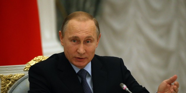 MOSCOW, RUSSIA - DECEMBER 9: Russian President Vladimir Putin gestures during a meeting with members of the Board of Trustees of the Mariinsky Theatre at the Kremlin on December 9, 2015 in Moscow, Russia. David Cameron and Vladimir Putin have agreed to 'work together' to defeat the Isis militant group.The commitment comes after a telephone conversation between the pair early on Wednesday, according to a Downing Street report of the diplomatic exchange. (Photo by Sasha Mordovets/Getty Images)