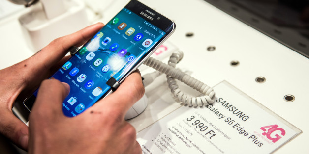 A customer browses a Samsung Electronics Co. Galaxy S6 Edge smartphone at a T-Mobile store, operated by Magyar Telekom Nyrt., in Budapest, Hungary, on Monday, Nov. 2, 2015. Magyar Telekom will announce third-quarter earnings on Wednesday. Photographer: Akos Stiller/Bloomberg via Getty Images