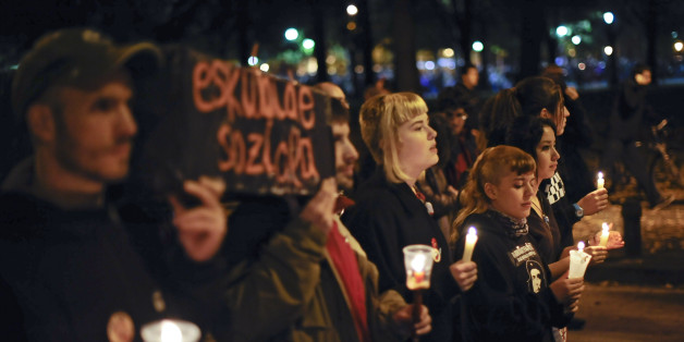 Youth demonstrators hold lit candles simulating a burial during a general strike against government austerity measures, in Pamplona, northern Spain, Wednesday, Nov. 14, 2012. A Spanish Interior Ministry official says 32 people have been arrested and 15 people treated for minor injuries in disturbances as a general strike in Spain against austerity measures and economic reforms began. The General Workers Union said the nationwide stoppage, the second this year, was being heeded by nearly 100 per