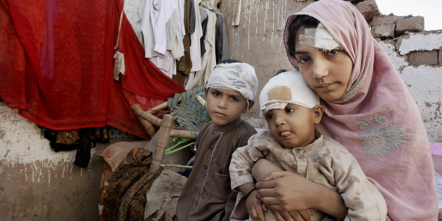 Pakistani children sit in the rubble of their home damaged from an earthquake in Peshawar, Pakistan, Wednesday, Oct. 28, 2015. Afghanistan and Pakistan were scrambling Wednesday to rush aid to survivors of this week's magnitude-7.5 earthquake as the region's overall death toll from the temblor rose to hundreds. (AP Photo/Mohammad Sajjad)