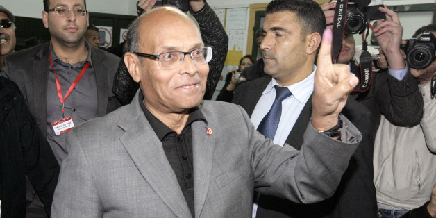 Tunisia's outgoing President, Moncef Marzouki, displays the indelible ink mark on his finger after voting in Sousse, 120 miles south of Tunis, Tunisia, Sunday, Dec, 21, 2014. Tunisians must decide Sunday between Beji Caid Essebsi, an 88-year-old veteran of previous regimes, and Moncef Marzouki, a 75-year-old human rights activist who is the outgoing interim president. For the third time in just two months, Tunisian voters will head to the polls this weekend, this time to elect a president in a runoff vote that presents a stark choice between the country's past and its Arab Spring revolution. (AP Photo/Slim Abid)