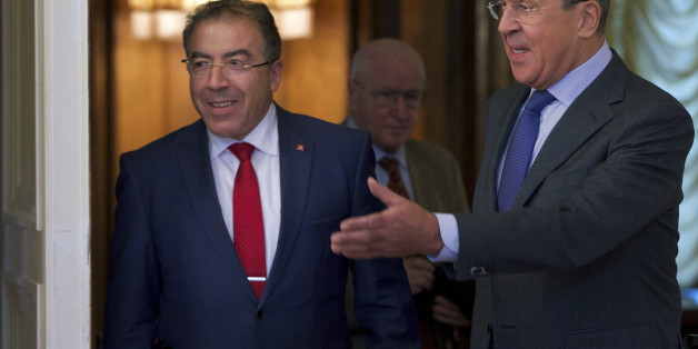 Russian Foreign Minister Sergey Lavrov, right, welcomes his Tunisian counterpart Mongi Hamdi during their talks in Moscow, Russia, Tuesday, Sept. 2, 2014. (AP Photo/Ivan Sekretarev)