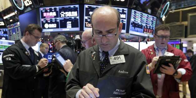 Trader Andrew Silverman, center, works on the floor of the New York Stock Exchange, Tuesday, Dec. 15, 2015. Stocks are climbing in early trading as buyers return to a market that has been mostly beaten down in recent days. (AP Photo/Richard Drew)
