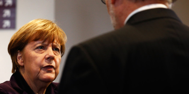 BRUSSELS, BELGIUM - DECEMBER 17: Chancellor of Germany, Angela Merkel speaks to the Prime Minister of Spain, Mariano Rajoy Brey during the family photo opportunity at The European Council Meeting In Brussels held at the Justus Lipsius Building on December 17, 2015 in Brussels, Belgium. European leaders are meeting to discuss David Camerons proposed EU reforms, as well as focussing on the migrant crisis, the fight against terrorism and climate change. (Photo by Dean Mouhtaropoulos/Getty Images)