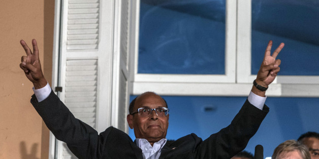 Tunisian presidential candidate Moncef Marzouki makes the V sign prior to give a speech, after the second round of the country's presidential election, in Tunis, Sunday, Dec. 21, 2014. Tunisian polling firms have declared Beji Caid Essebsi, an 88-year-old official from previous regimes, as the winner of Sunday's presidential runoff, cementing his dominance over a country where his party already controls Parliament. (AP Photo/Ilyess Osmane)