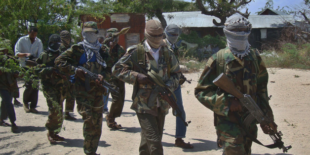 Al-Qaeda linked al-shabab recruits walk down a street on March 5, 2012 in the Deniile district of the Somalian capital, Mogadishu, following their graduation. The walls of the former Shebab base in Baidoa, Somalia, are littered with rudimentary drawings of machine guns and tanks, a note reading 'Fear God, don't write on these walls' and a sketch of an Al-Qaeda flag, homage to the rebel group's international allies. The crumbling building is now occupied by Ethiopian troops who nearly two weeks ago forced Shebab rebels out of Baidoa, their former Shebab stronghold and Somalia's third-largest city. AFP PHOTO / Mohamed ABDIWAHAB (Photo credit should read Mohamed Abdiwahab/AFP/Getty Images)