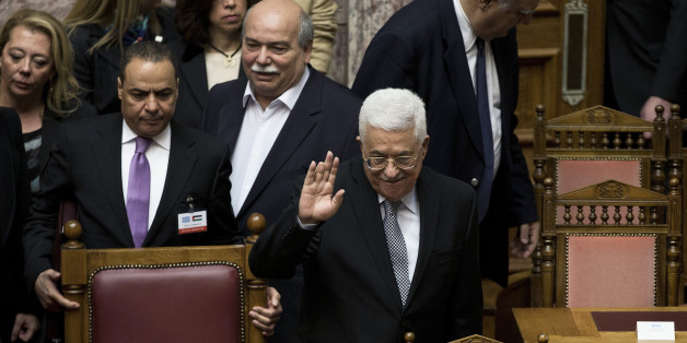 Palestinian President Mahmoud Abbas, waves to Greek lawmakers during his arrival at the Greek parliament in Athens , on Tuesday, Dec. 22, 2015. Greek lawmakers have unanimously approved a resolution calling on the country's left-led government to formally recognize Palestinian statehood.(AP Photo/Petros Giannakouris)