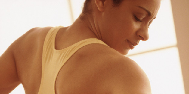 Woman holding her strained back