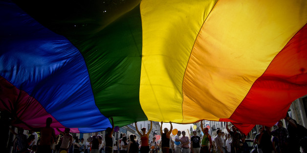 People wave a giant rainbow flag during the Gay Pride Parade in Lisbon on June 22, 2013. AFP PHOTO/ PATRICIA DE MELO MOREIRA (Photo credit should read PATRICIA DE MELO MOREIRA/AFP/Getty Images)