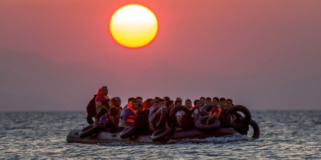 FILE - Migrants on a dinghy arrives at the southeastern island of Kos, Greece, after crossing from Turkey, Thursday, Aug. 13, 2015. Greece has become the main gateway to Europe for tens of thousands of refugees and economic migrants, mainly Syrians fleeing war, as fighting in Libya has made the alternative route from north Africa to Italy increasingly dangerous. (AP Photo/Alexander Zemlianichenko, File)