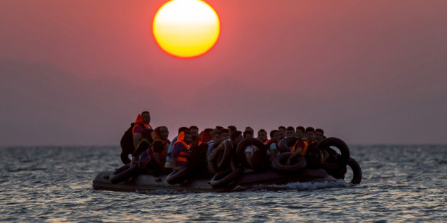 FOR USE AS DESIRED, YEAR END PHOTOS - FILE - Migrants on a dinghy arrives at the southeastern island of Kos, Greece, after crossing from Turkey, Thursday, Aug. 13, 2015. Greece has become the main gateway to Europe for tens of thousands of refugees and economic migrants, mainly Syrians fleeing war, as fighting in Libya has made the alternative route from north Africa to Italy increasingly dangerous. (AP Photo/Alexander Zemlianichenko, File)