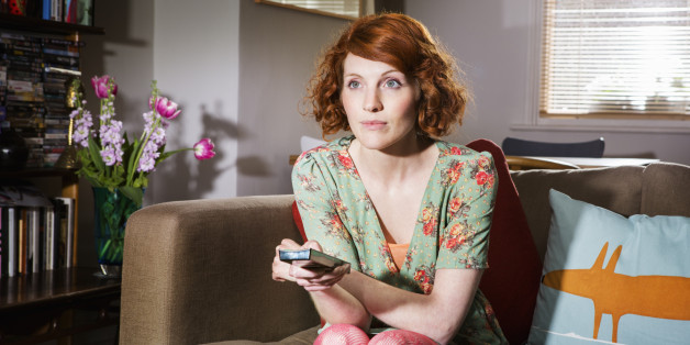 Woman watching tv in livingroom.
