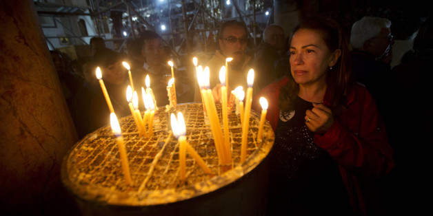 A Christian worshipper lights a candle at the Church of the Nativity, where Christians believe Jesus Christ was born, in the West Bank city of Bethlehem, Wednesday, Dec. 23, 2015. (AP Photo/Majdi Mohammed)