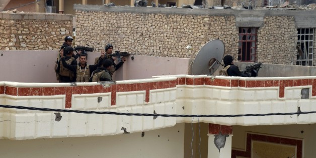 Iraqi security forces, supported by U.S.-led coalition airstrikes, advance their position through damaged buildings towards the central Ramadi, 70 miles (115 kilometers) west of Baghdad, Iraq, Thursday, Dec. 24, 2015. The advance of government forces in the Islamic State-held city of Ramadi is being hampered by suicide bombers, snipers and booby traps, Gen. Ismail al-Mahlawi, the head of Iraqi military operations in Anbar said. (AP Photo)