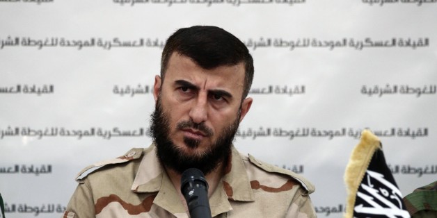 Zahran Alloush, the leader of Jaysh al-Islam (Islam Army) and military leader of the Islamic Front, attends a press conference with other brigade leaders in the rebel-held Eastern Ghouta region outside the capital Damascus on August 27, 2014, to announce the fomation of 'The Unified Military Command of Eastern Ghouta'. The unified command consists of Ajnad al-Sham (Soldiers of the Levant), the Islam army, Ahrar ash-Sham and Rahman brigade. AFP PHOTO/ABD DOUMANY (Photo credit should read ABD DOUMANY/AFP/Getty Images)