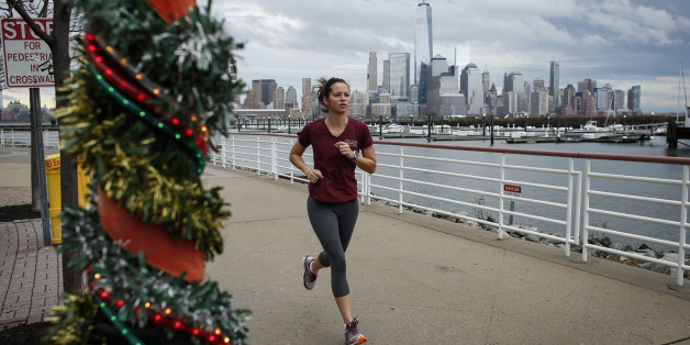 NEWPORT, NJ - DECEMBER 24: A woman jogs along the Hudson River shore on December 24, 2015 in Newport, New Jersey. New York and New Jersey have seen highs in the upper 50s this week, with temperatures expected to reach the low 70s on Christmas Eve. (Photo by Kena Betancur/Getty Images)
