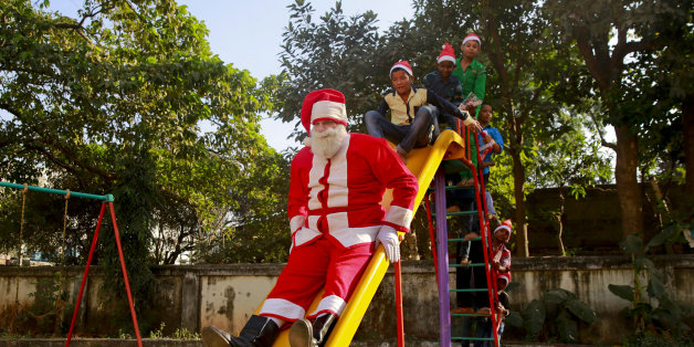 Bollywood actor Brandon Hill dressed as Santa Claus plays with underprivileged children at a Christmas party organized by a social organization in Mumbai, India, Tuesday, Dec. 22, 2015. Though Hindus and Muslims comprise the majority of the population in India, Christmas is celebrated with much fanfare. (AP Photo/Rafiq Maqbool)