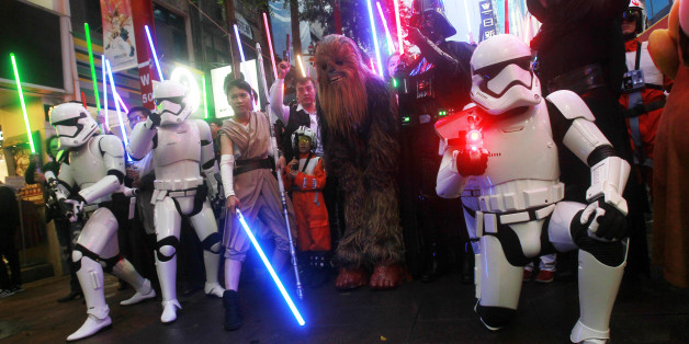 Fans dressed as Star Wars characters parade outside a movie theater showing "Star Wars: The Force Awakens" Saturday, Dec. 19, 2015, in Taipei, Taiwan. (AP Photo/Chiang Ying-ying)