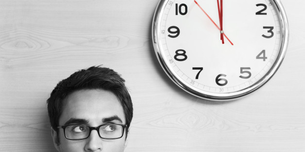 Anxious Businessman Looking at Office Clock
