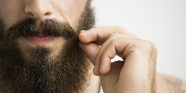 Close up of man touching mustache