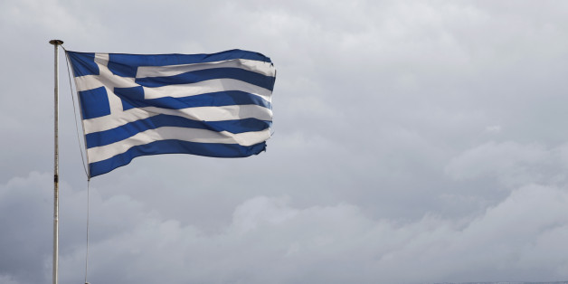 Greek flags wave in front of the snow covered Mount Hymettus in Athens, on Wednesday, Feb. 11, 2015. Greece's new government confronts its eurozone creditors Wednesday at an emergency meeting in Brussels as it seeks to ease the terms of its bailout program in the face of strong resistance from its partners.(AP Photo/Petros Giannakouris)